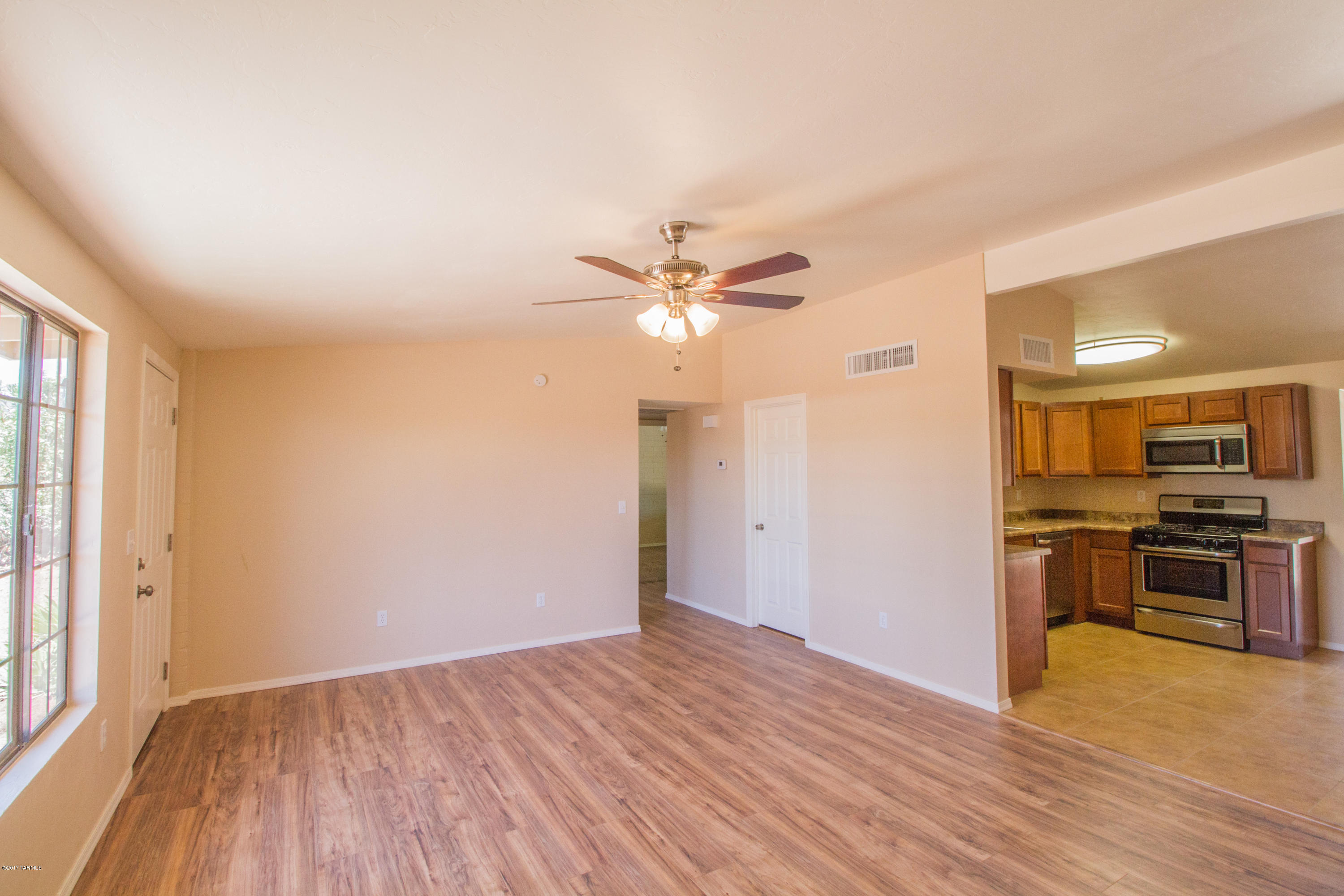2002 West Saxony Road Tucson, AZ 85713 - Photo 7 of 22 a view of a kitchen with a ceiling fan hardwood floor and a ceiling fan