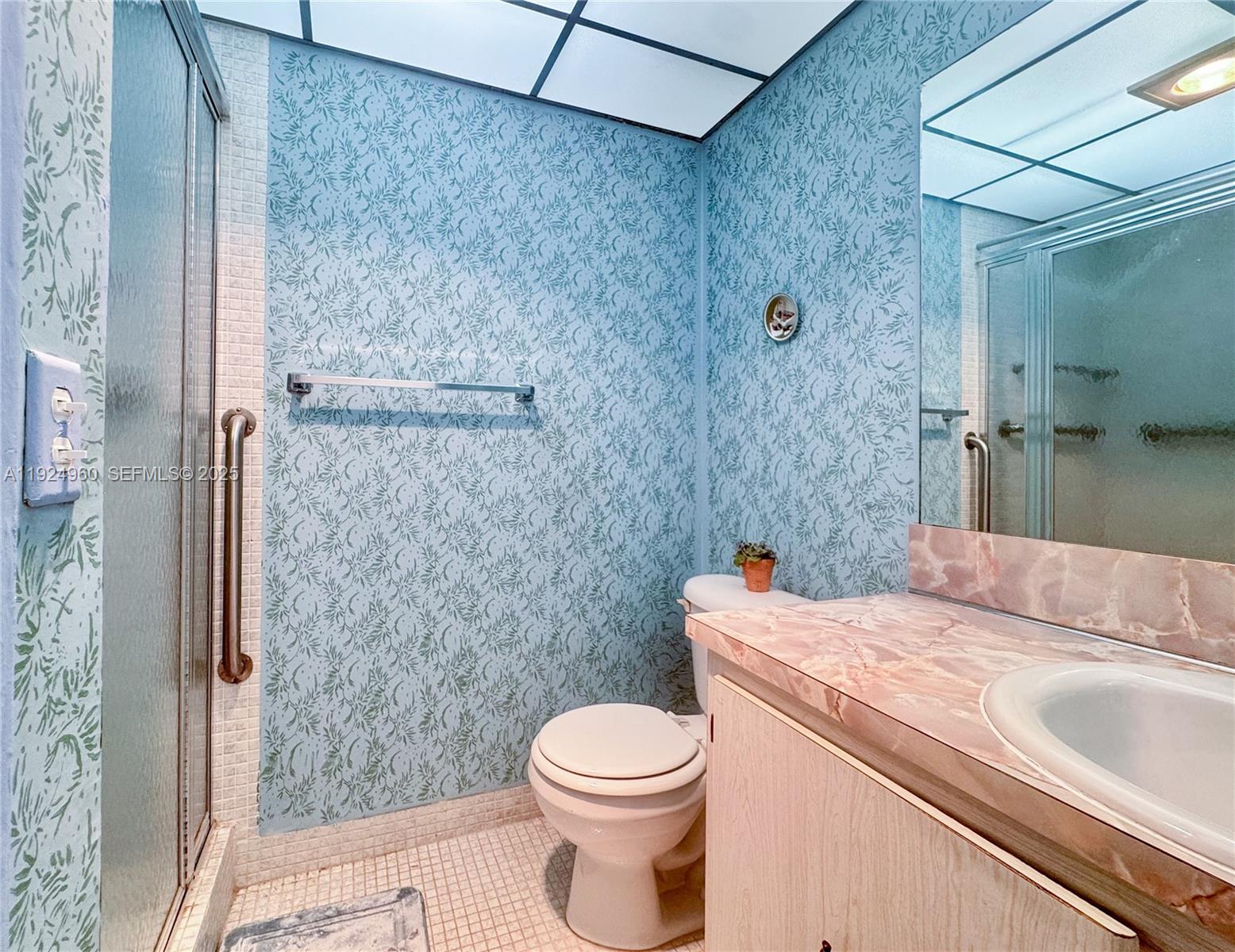 612 Normandy Lane, Unit 612 Delray Beach, FL 33484 - Photo 11 of 18 a bathroom with a sink toilet and shower