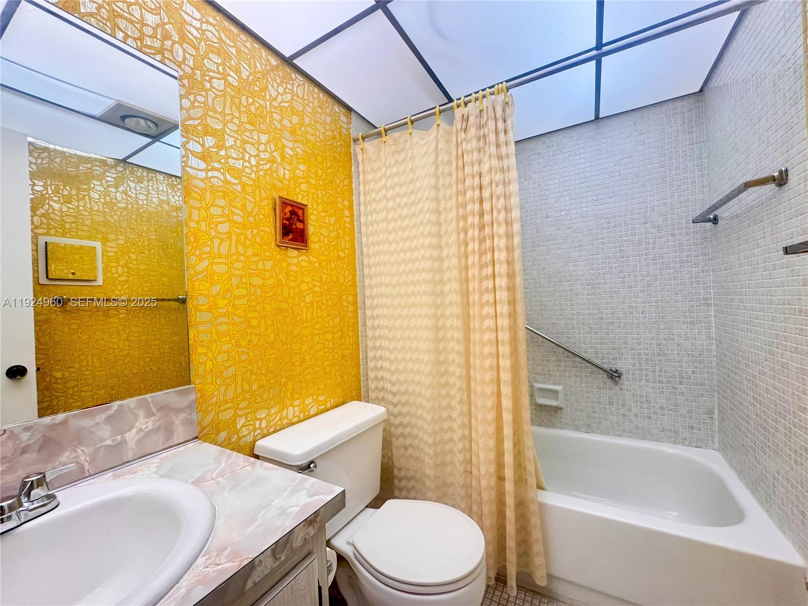 612 Normandy Lane, Unit 612 Delray Beach, FL 33484 - Photo 13 of 18 a bathroom with a sink toilet and shower