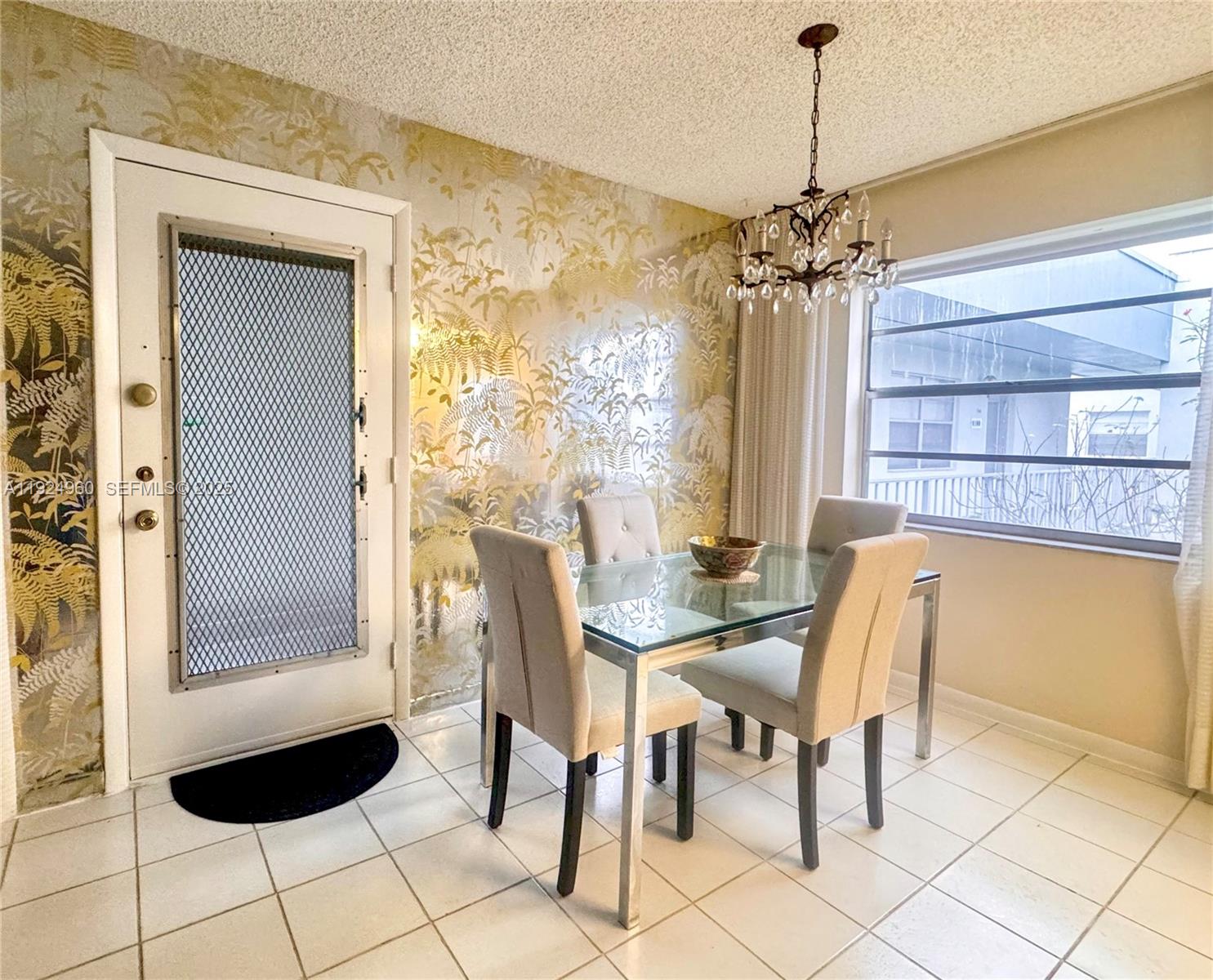 612 Normandy Lane, Unit 612 Delray Beach, FL 33484 - Photo 3 of 18 a view of a dining room with furniture and a window