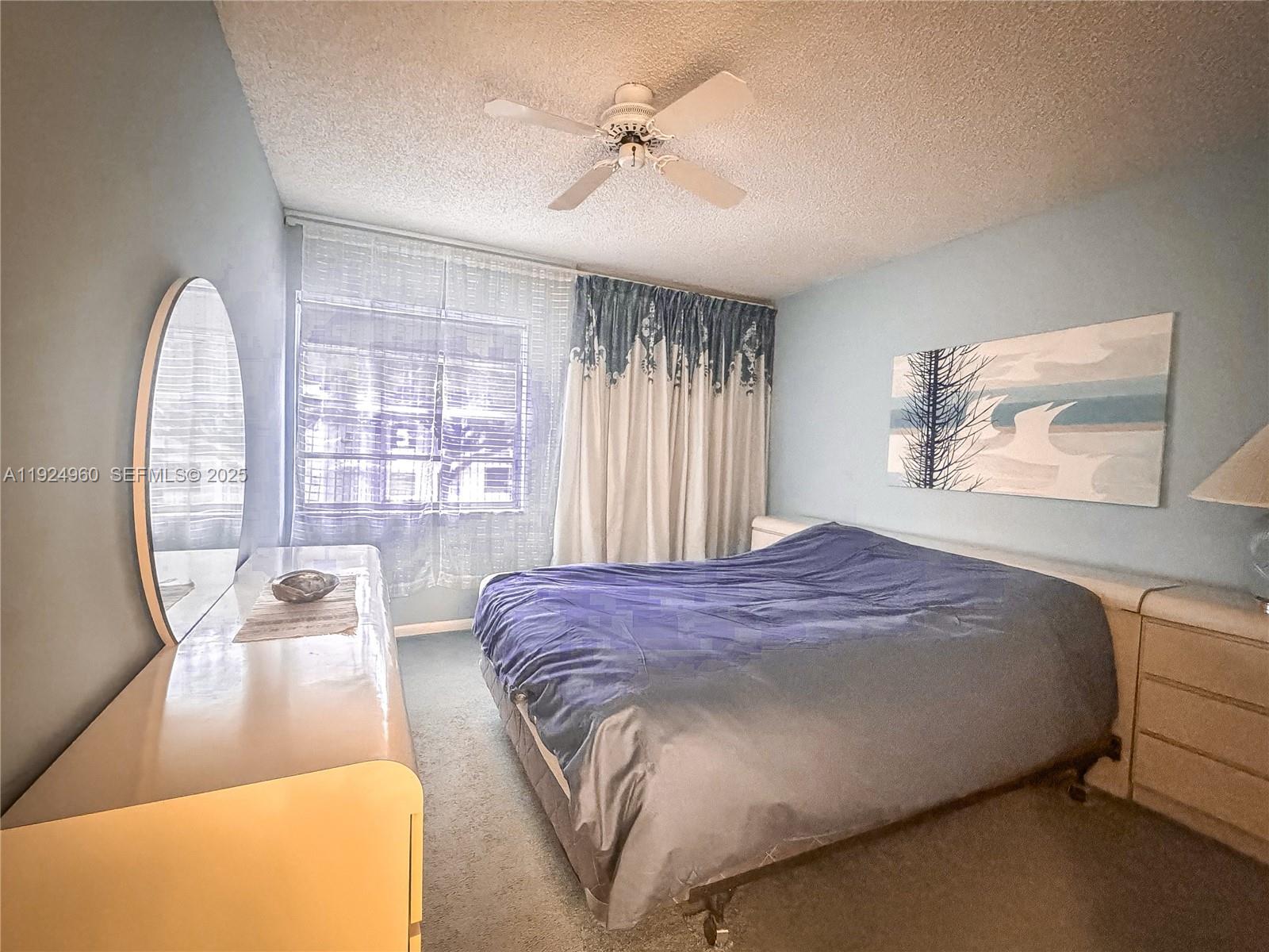 612 Normandy Lane, Unit 612 Delray Beach, FL 33484 - Photo 7 of 18 a bedroom with a bed and a large window