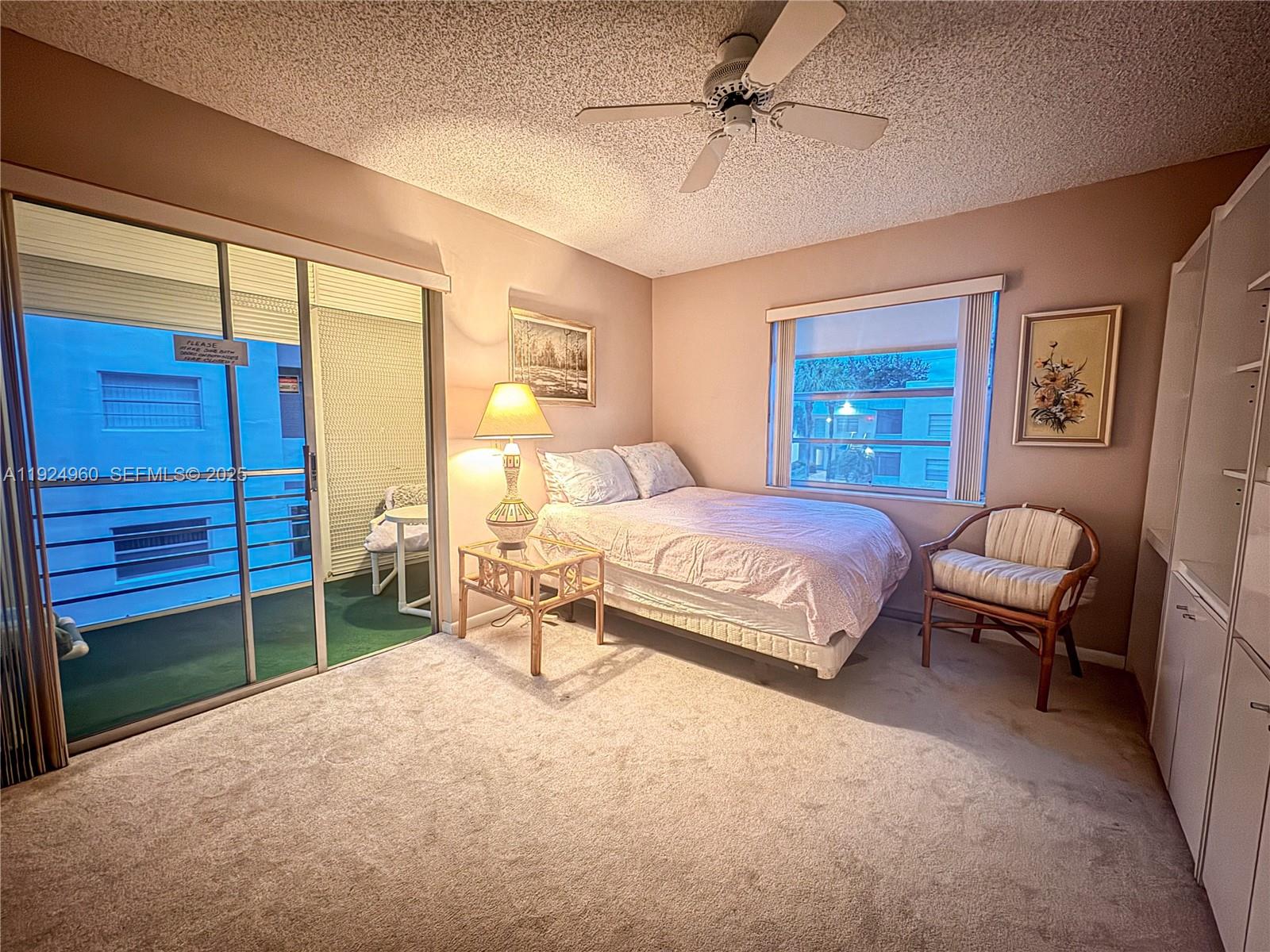 612 Normandy Lane, Unit 612 Delray Beach, FL 33484 - Photo 8 of 18 a bedroom with a bed and a dresser