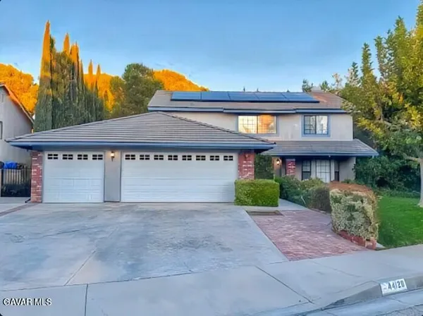 a front view of a house with a yard and a garage