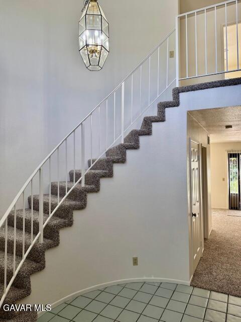44128 Fine Circle Lancaster, CA 93536 - Photo 11 of 63 a view of staircase with lots of frames on wall and a table