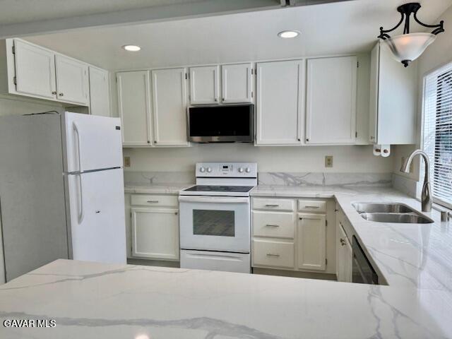 44128 Fine Circle Lancaster, CA 93536 - Photo 19 of 63 a kitchen with white cabinets and stainless steel appliances