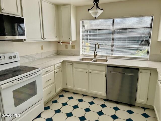 44128 Fine Circle Lancaster, CA 93536 - Photo 21 of 63 a kitchen with a stove a sink and a microwave