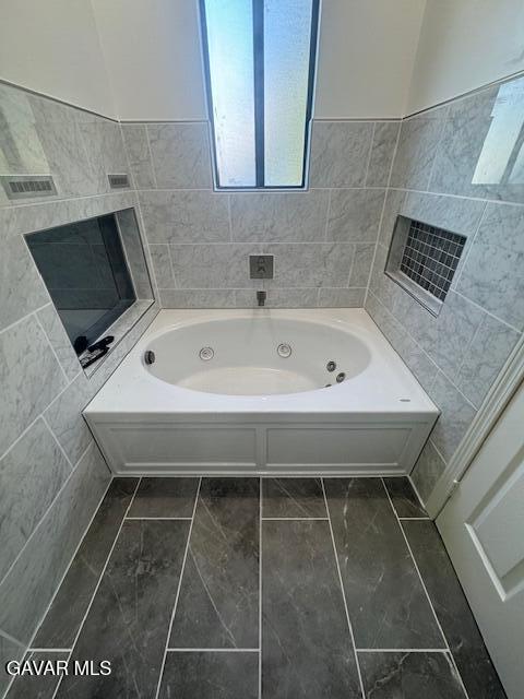 44128 Fine Circle Lancaster, CA 93536 - Photo 45 of 63 a bathroom with a bathtub and a sink