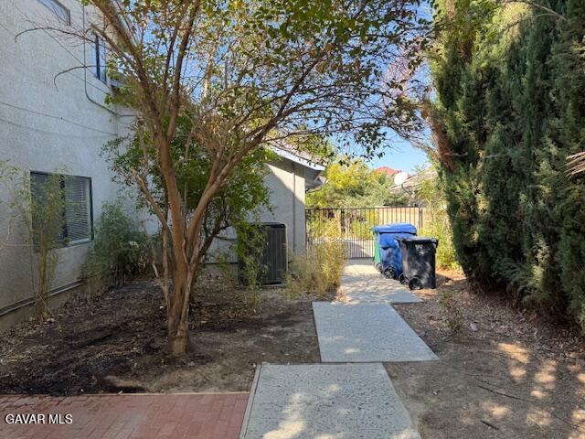 44128 Fine Circle Lancaster, CA 93536 - Photo 59 of 63 a view of a patio with table and chairs with wooden fence and large trees