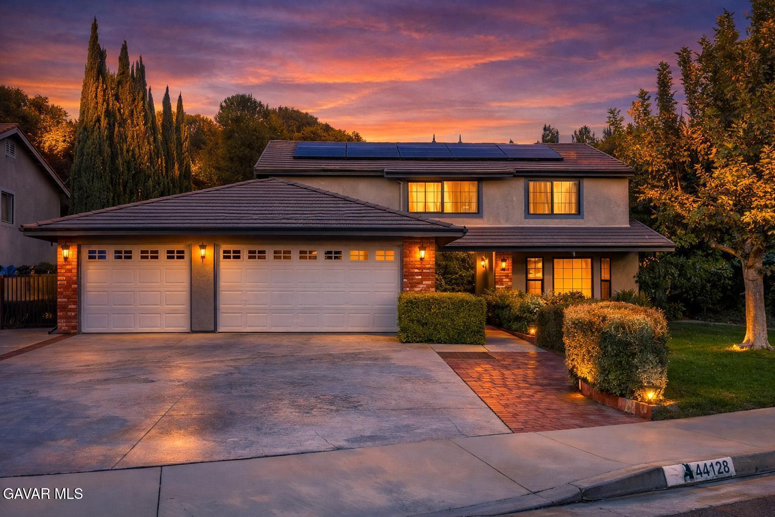 44128 Fine Circle Lancaster, CA 93536 - Photo 6 of 63 a front view of a house with a yard and garage