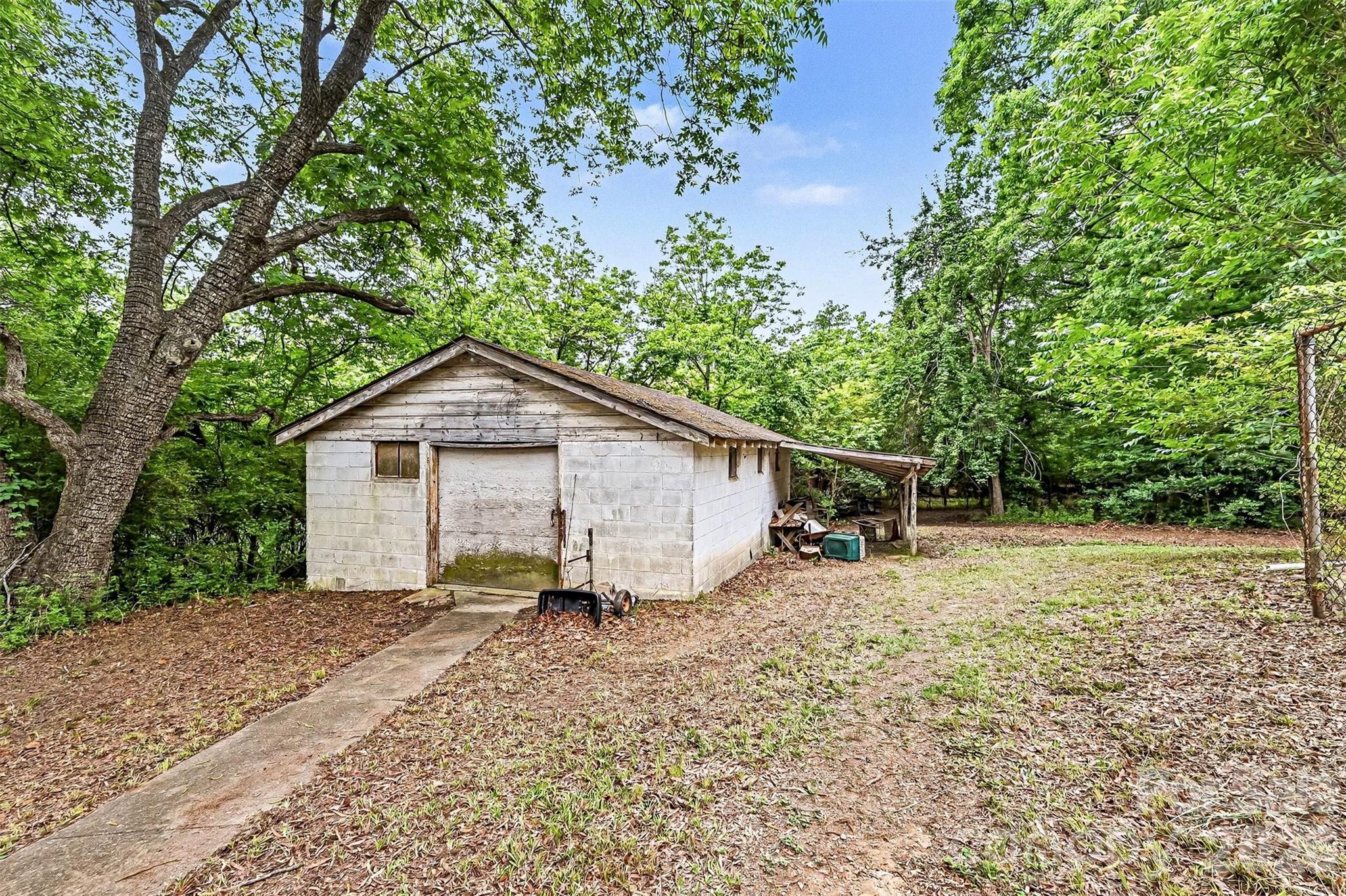 1116 Medlin Road Monroe, NC 28112 - Photo 30 of 40 a view of a house with a yard and large trees