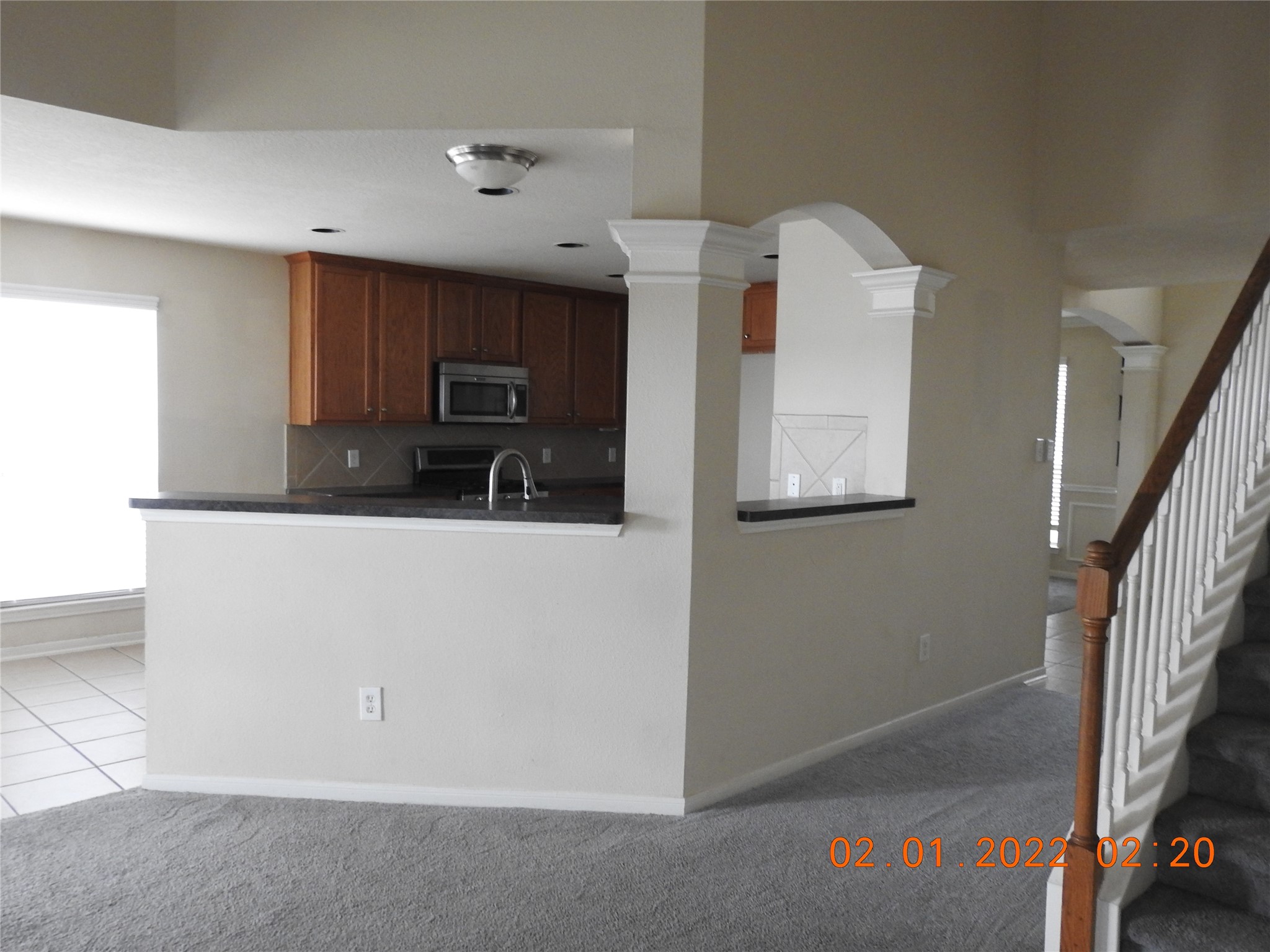 24227 Silversmith Lane Katy, TX 77493 - Photo 14 of 42 a kitchen with granite countertop a refrigerator and a microwave
