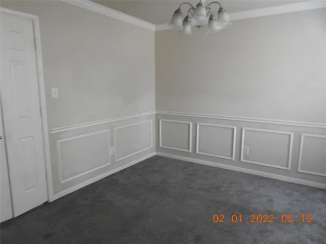 an empty room with chandelier fan