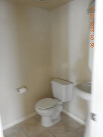a white toilet sitting next to a white sink
