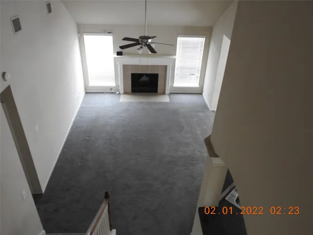a view of an empty room with a fireplace