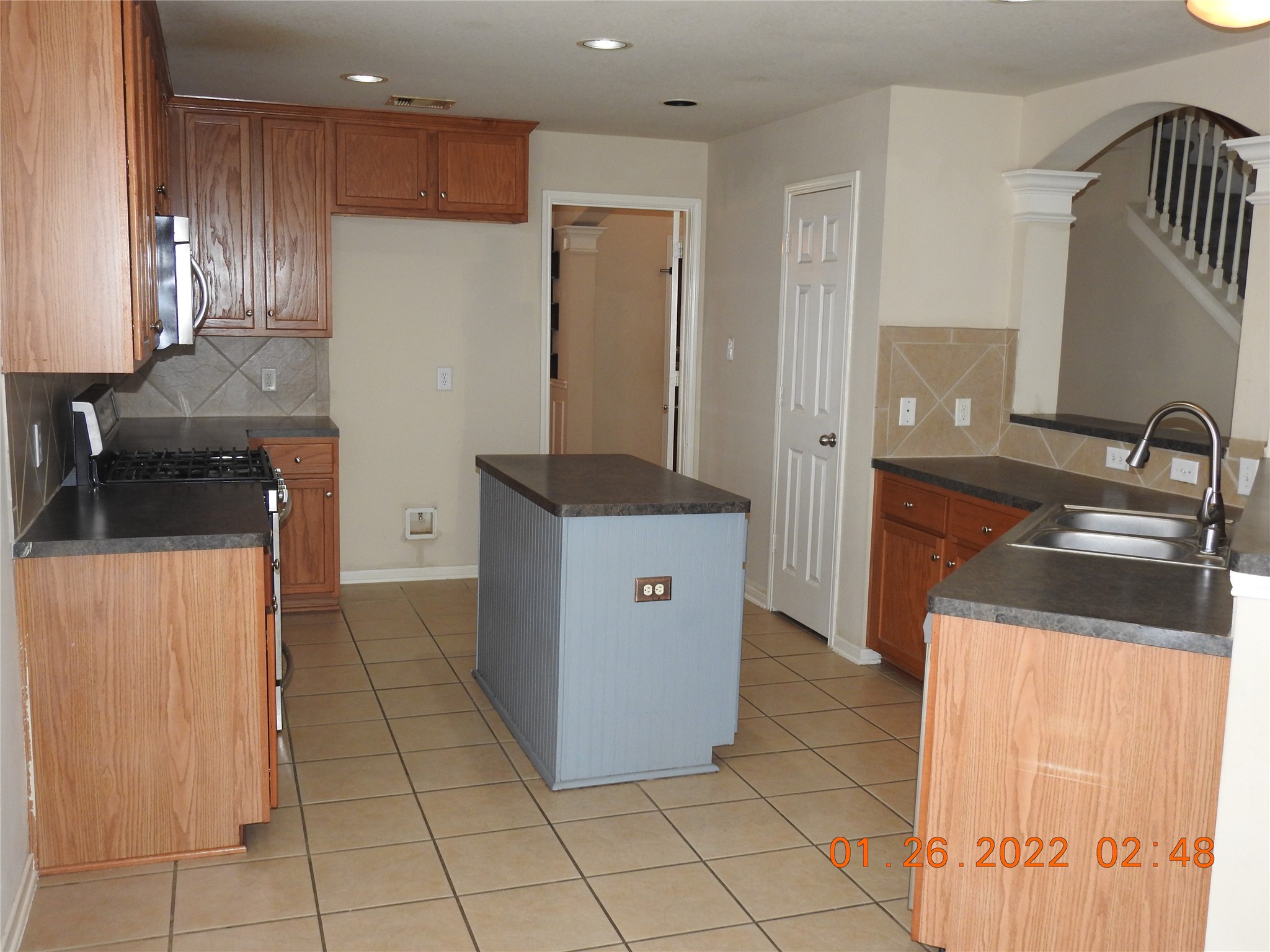 24227 Silversmith Lane Katy, TX 77493 - Photo 7 of 42 a kitchen with a sink a refrigerator and cabinets
