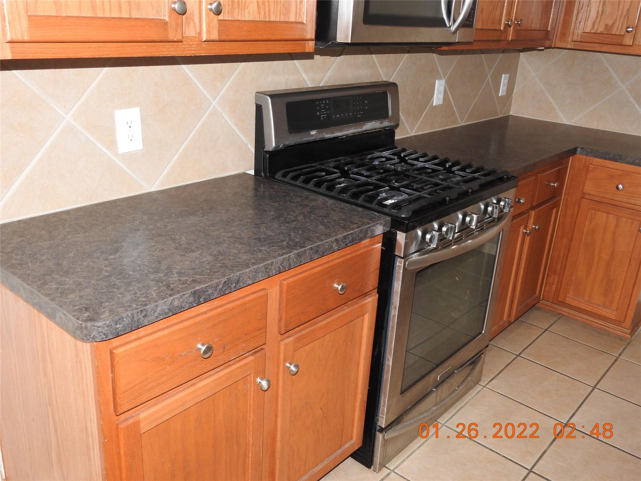 24227 Silversmith Lane Katy, TX 77493 - Photo 9 of 42 a kitchen with granite countertop a stove and a sink