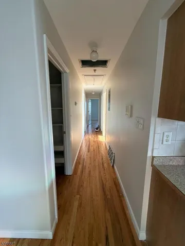 a view of a hallway view with wooden floor and staircase