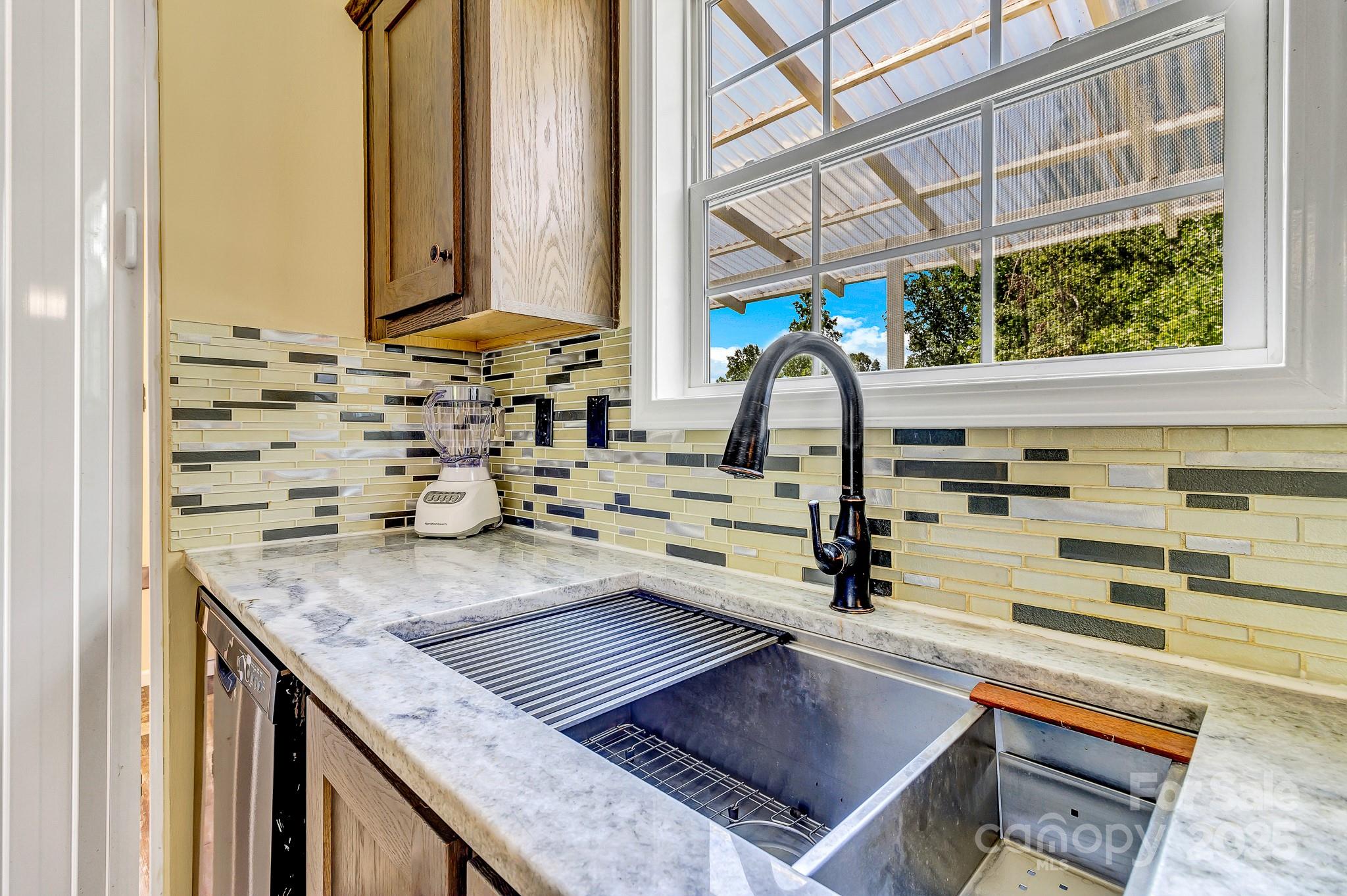 185 Bradshaw Circle Candler, NC 28715 - Photo 12 of 38 a kitchen with a stove a sink and a window
