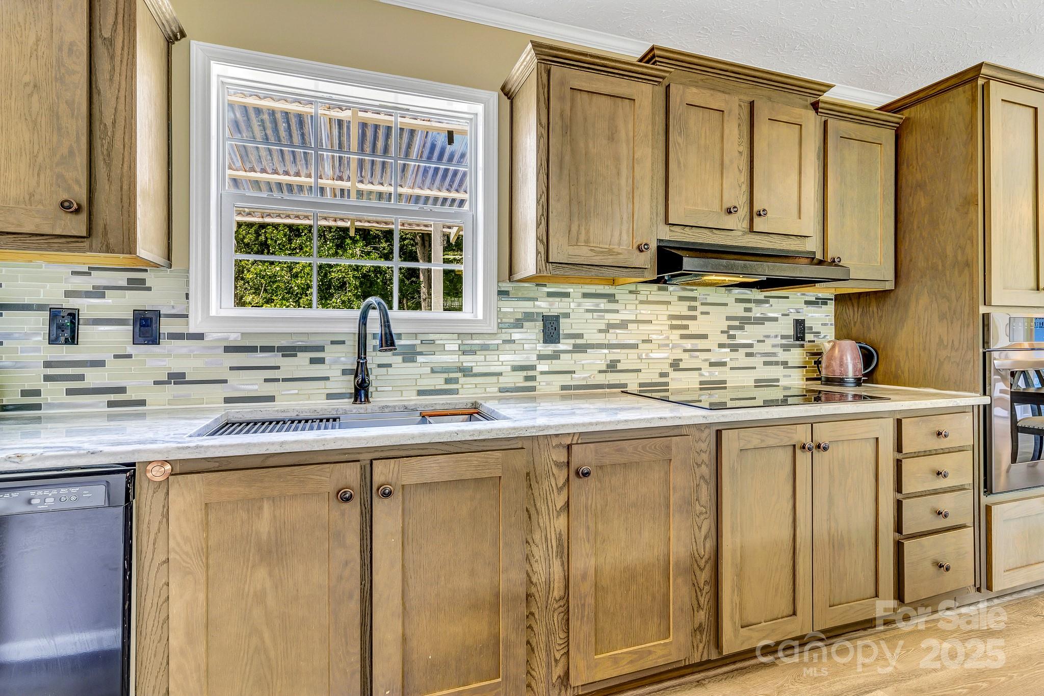 185 Bradshaw Circle Candler, NC 28715 - Photo 13 of 38 a kitchen with stainless steel appliances granite countertop a sink and a window