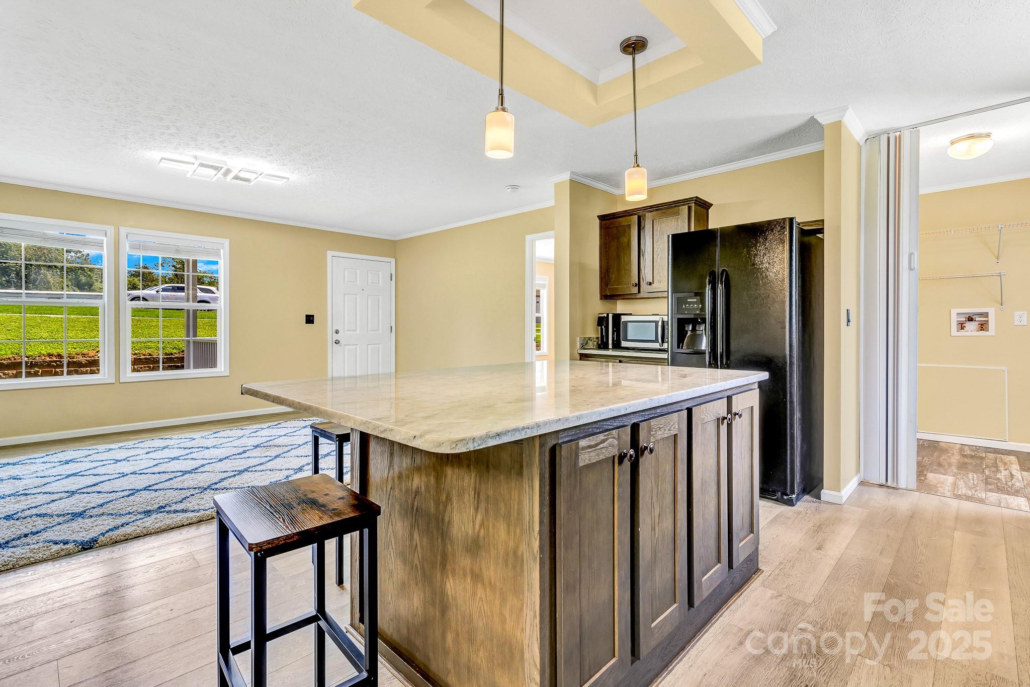 185 Bradshaw Circle Candler, NC 28715 - Photo 14 of 38 a kitchen with a table chairs refrigerator and cabinets