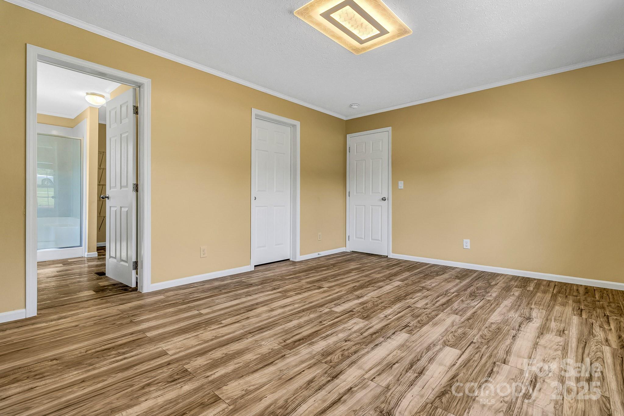 185 Bradshaw Circle Candler, NC 28715 - Photo 20 of 38 a view of an empty room with wooden floor and a window