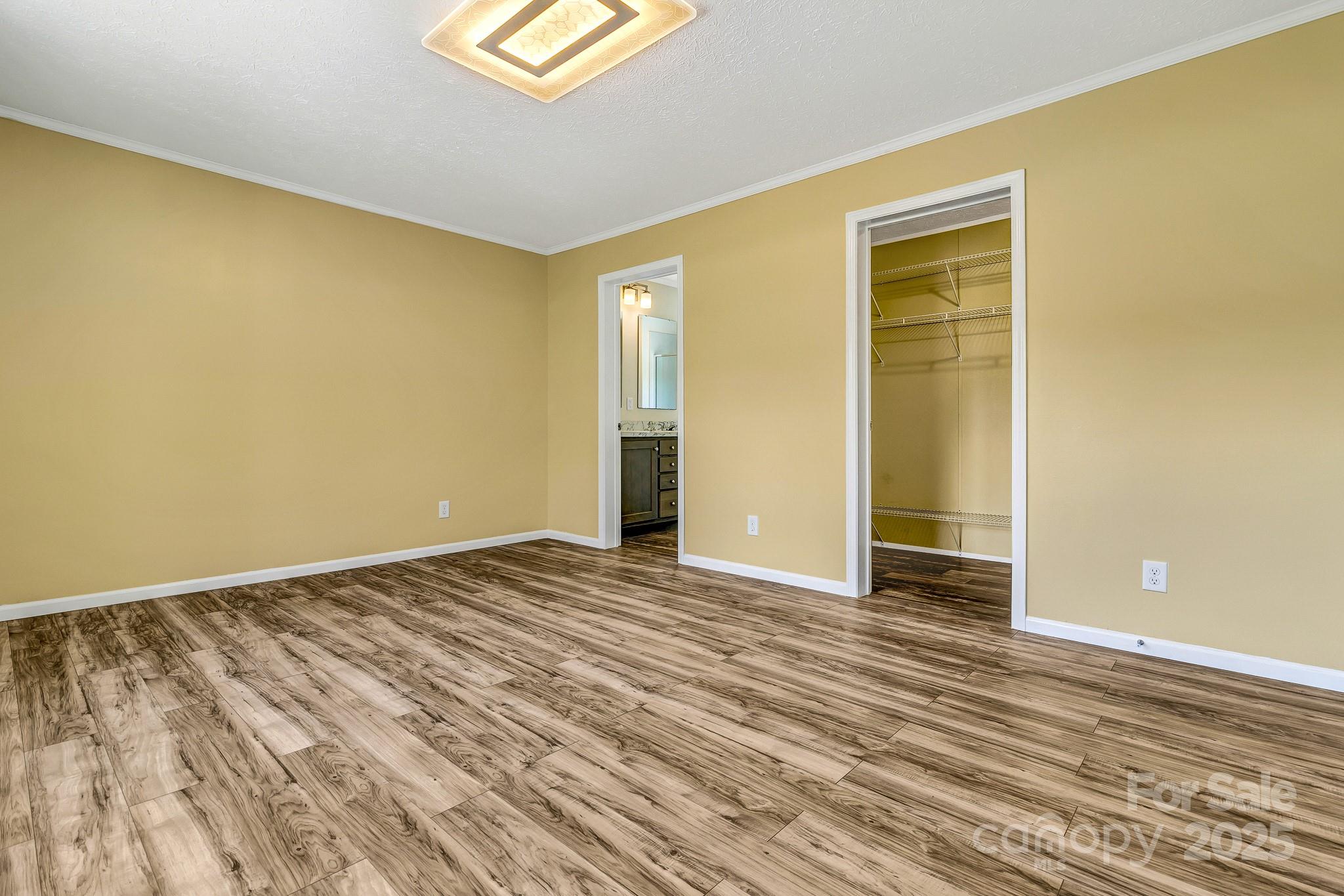 185 Bradshaw Circle Candler, NC 28715 - Photo 21 of 38 a view of an empty room with wooden floor and a window