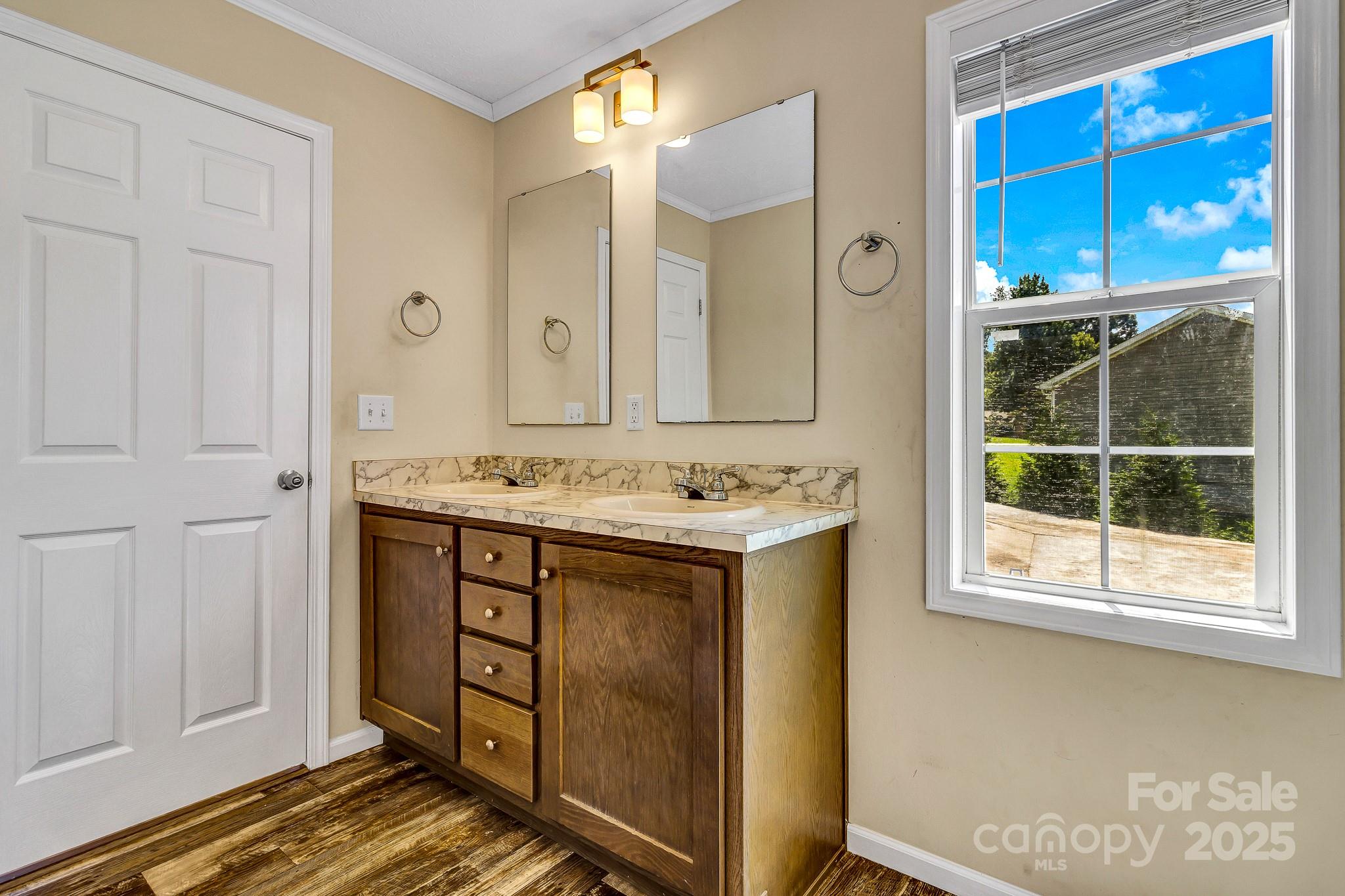 185 Bradshaw Circle Candler, NC 28715 - Photo 23 of 38 a bathroom with a granite countertop sink and a mirror