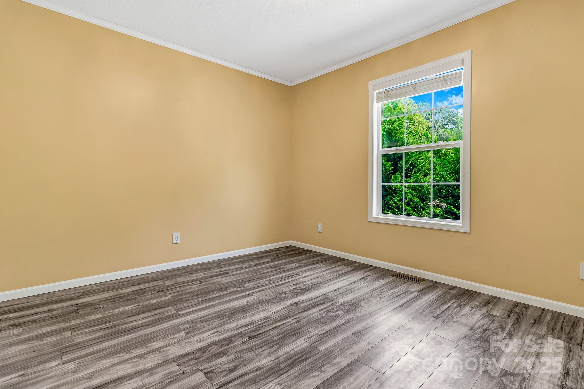 185 Bradshaw Circle Candler, NC 28715 - Photo 30 of 38 a view of an empty room with wooden floor and a window