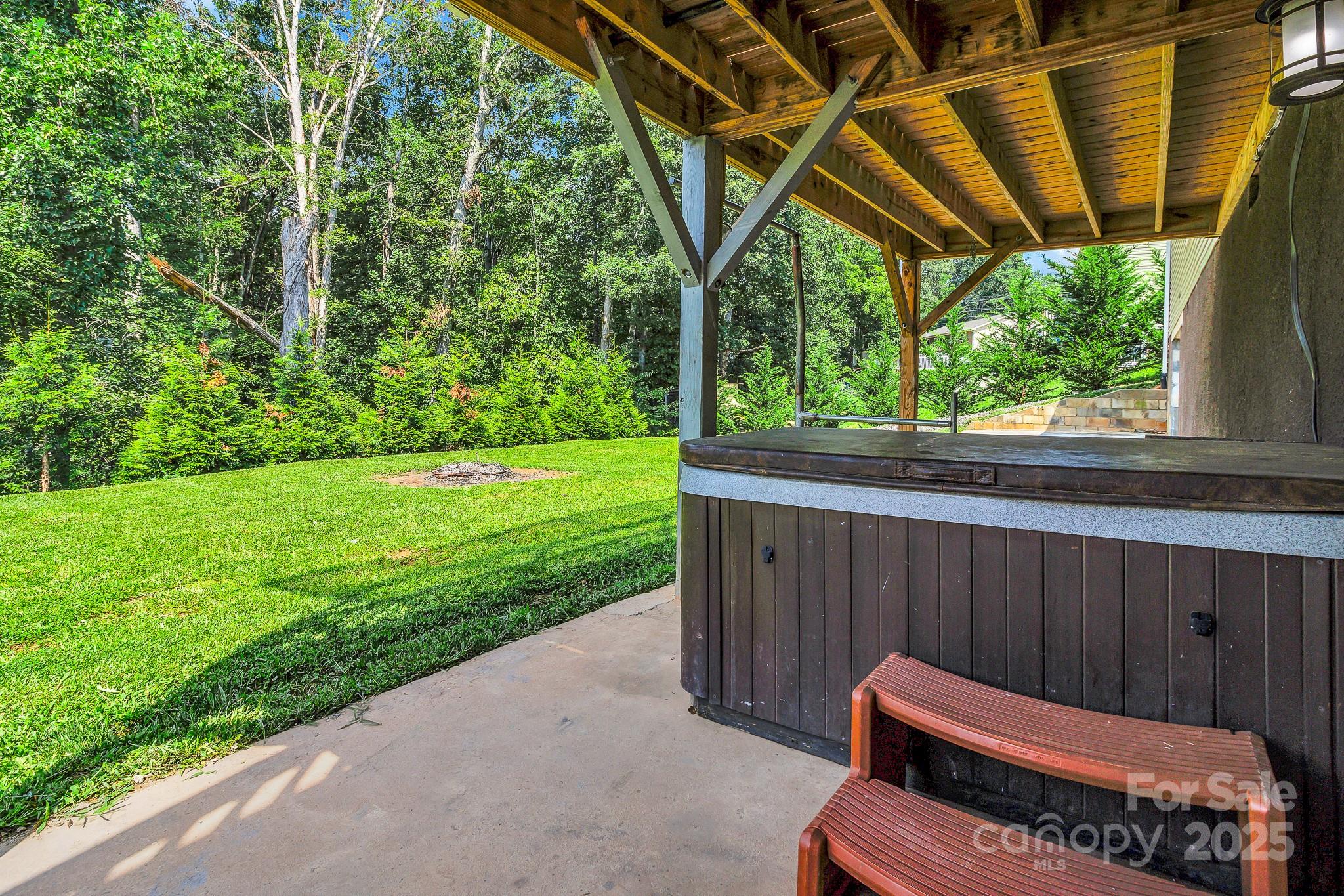 185 Bradshaw Circle Candler, NC 28715 - Photo 35 of 38 a backyard of a house with wooden floor and outdoor seating