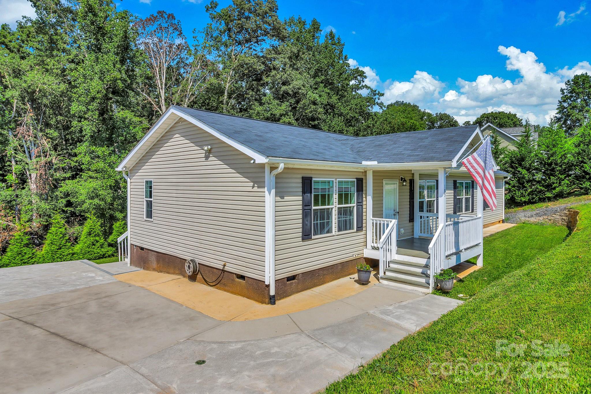 185 Bradshaw Circle Candler, NC 28715 - Photo 4 of 38 a view of a house with a yard plants and large tree