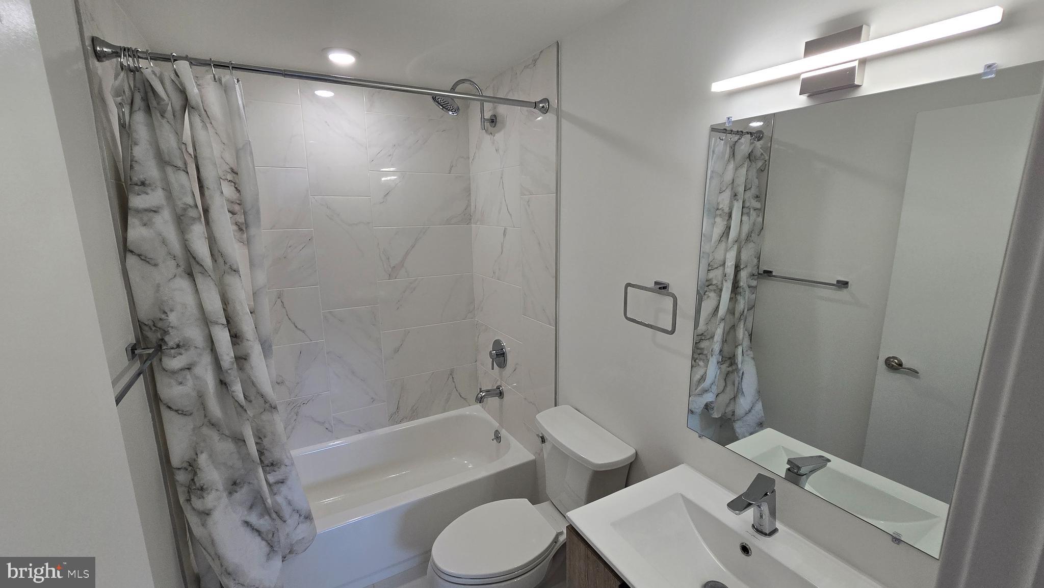 300 Budd Street, Unit C1 Philadelphia, PA 19104 - Photo 19 of 20 a bathroom with a sink toilet and shower