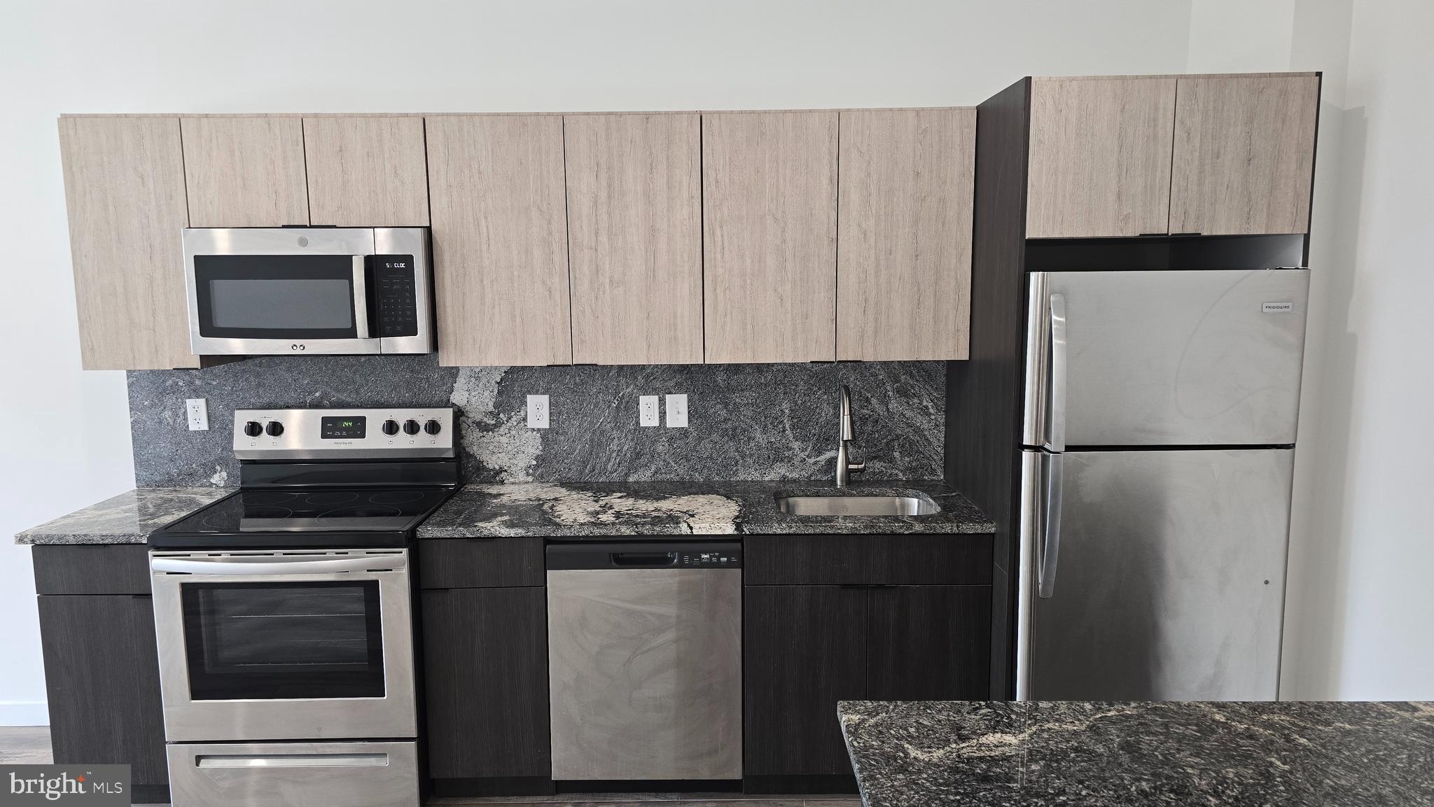 300 Budd Street, Unit C1 Philadelphia, PA 19104 - Photo 7 of 20 a kitchen with a refrigerator stove and microwave