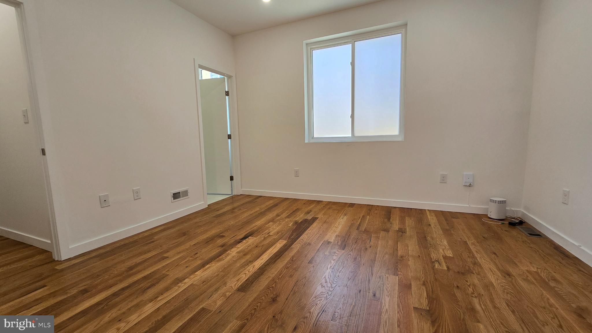 300 Budd Street, Unit C1 Philadelphia, PA 19104 - Photo 8 of 20 a view of a room with wooden floor and white walls