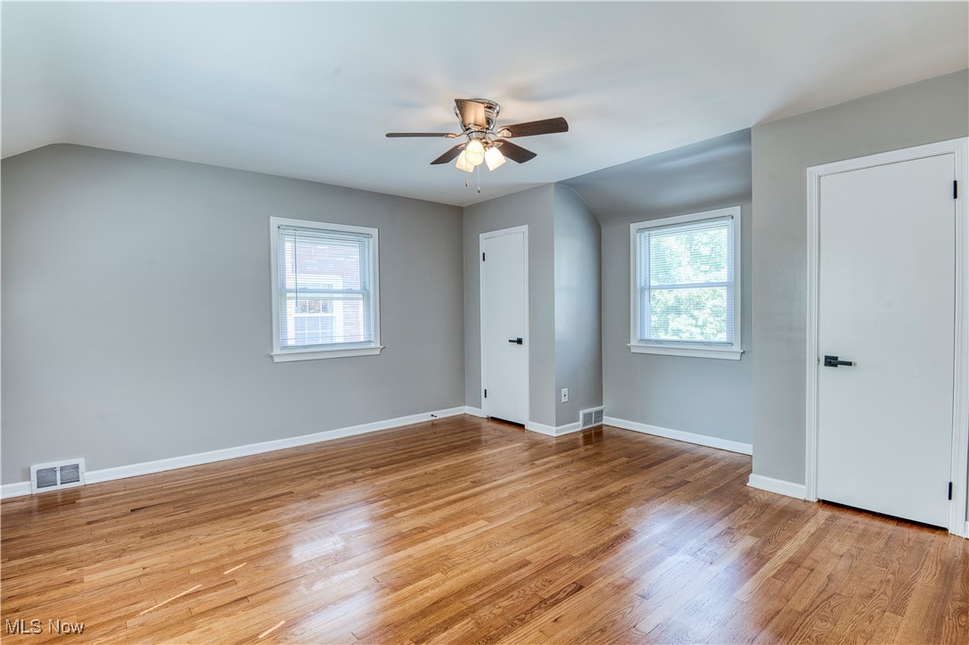 4520 Birchwold Road Cleveland, OH 44121 - Photo 19 of 40 Empty room with hardwood / wood-style flooring, a wealth of natural light, and ceiling fan
