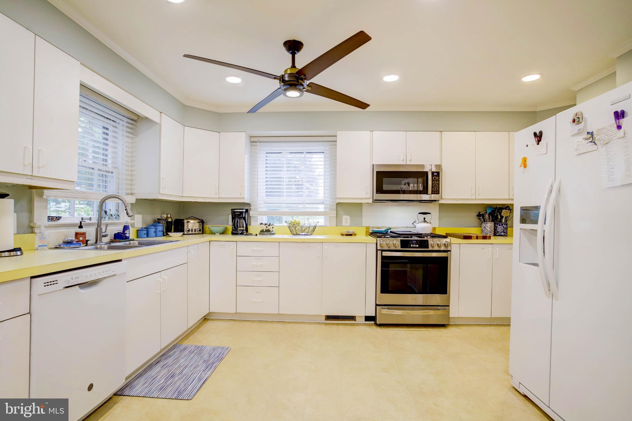 24800 Pealiquor Road Denton, MD 21629 - Photo 17 of 114 a kitchen with granite countertop a refrigerator stove top oven and sink