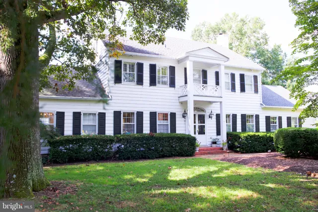 a front view of a residential apartment building with a yard