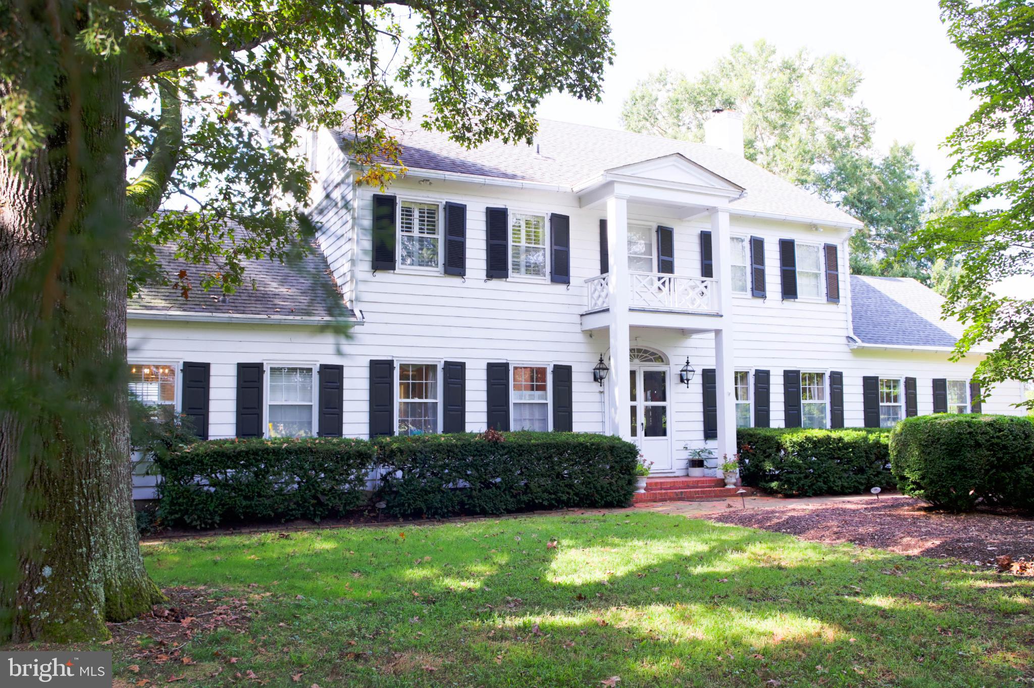 24800 Pealiquor Road Denton, MD 21629 - Photo 3 of 114 a front view of a house with a yard and garage