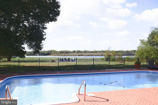 a living room with stainless steel appliances granite countertop furniture a fireplace and a large window