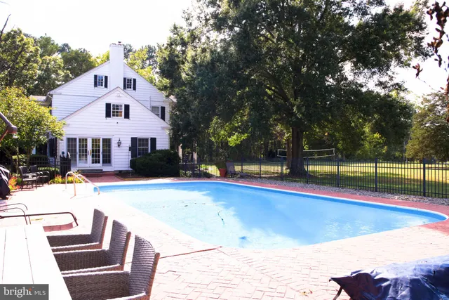 a room with pool table and windows