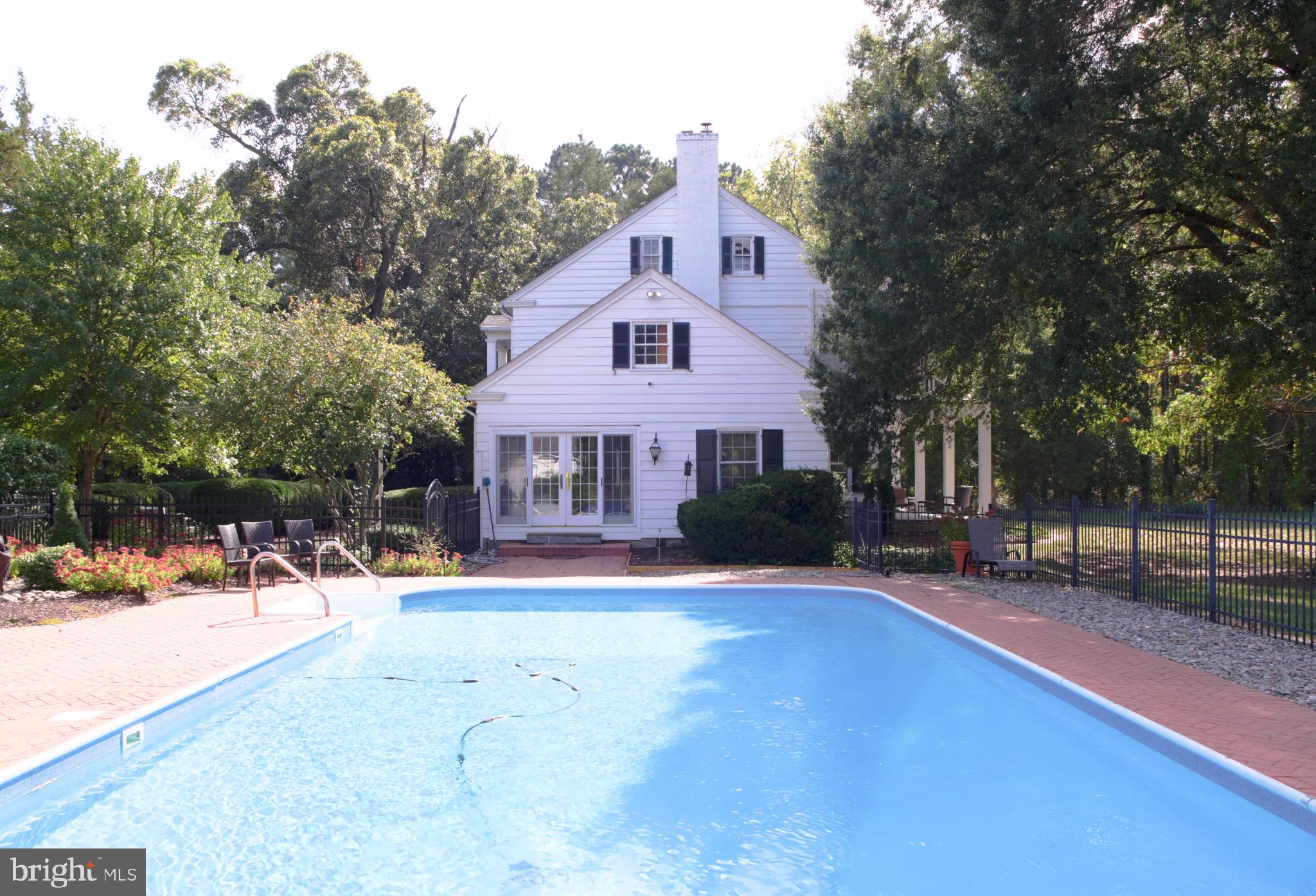 24800 Pealiquor Road Denton, MD 21629 - Photo 34 of 114 a front view of a house with a yard and trees