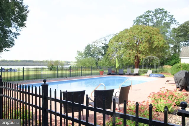 a view of staircase with railing and a large window