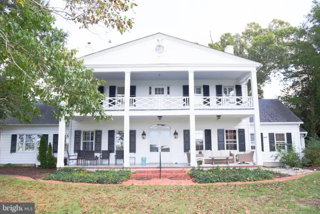 a front view of a house with yard and green space