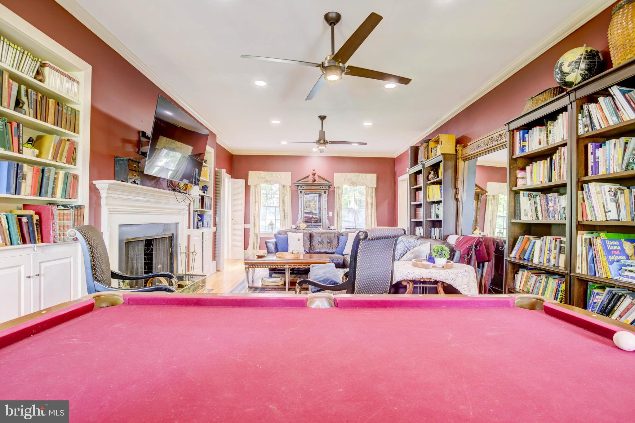 24800 Pealiquor Road Denton, MD 21629 - Photo 77 of 114 a living room with fireplace furniture and a book shelf
