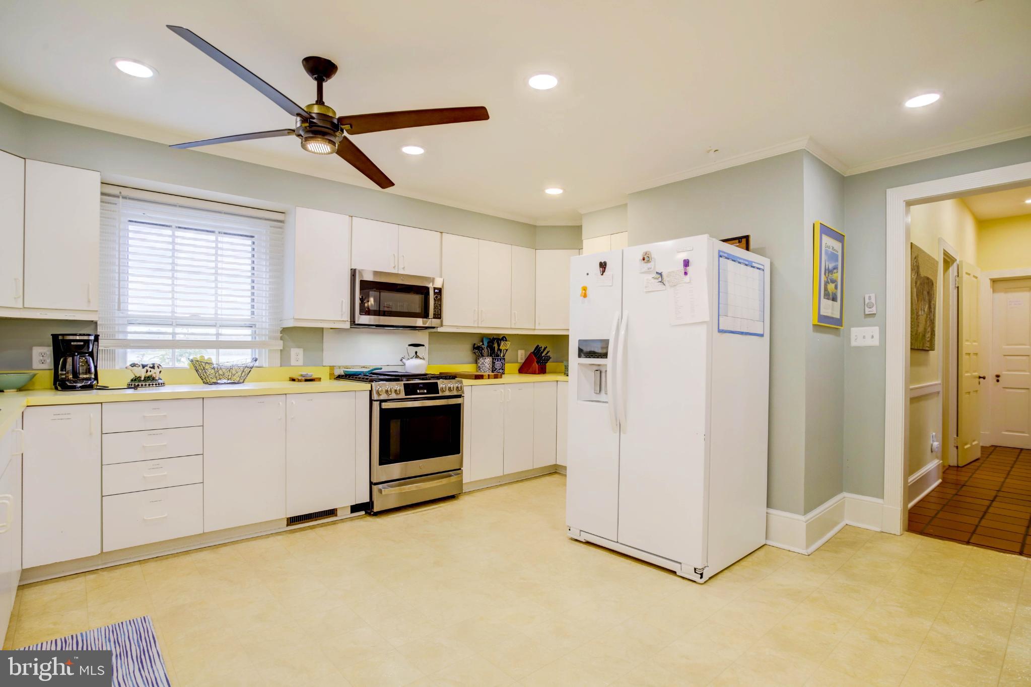 24800 Pealiquor Road Denton, MD 21629 - Photo 91 of 114 a kitchen with granite countertop a refrigerator oven a sink dishwasher with a dining table and chairs