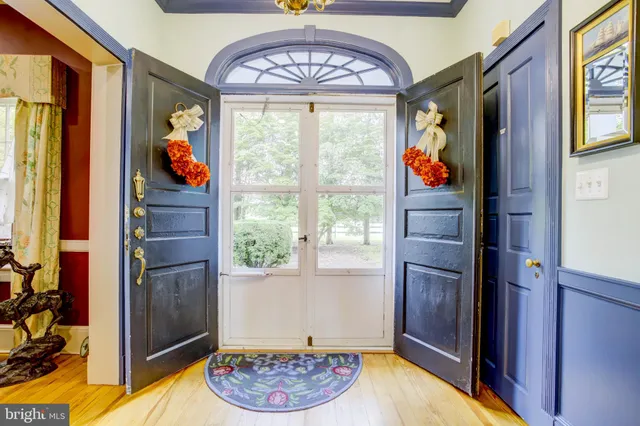 a view of a dining room with furniture and a chandelier