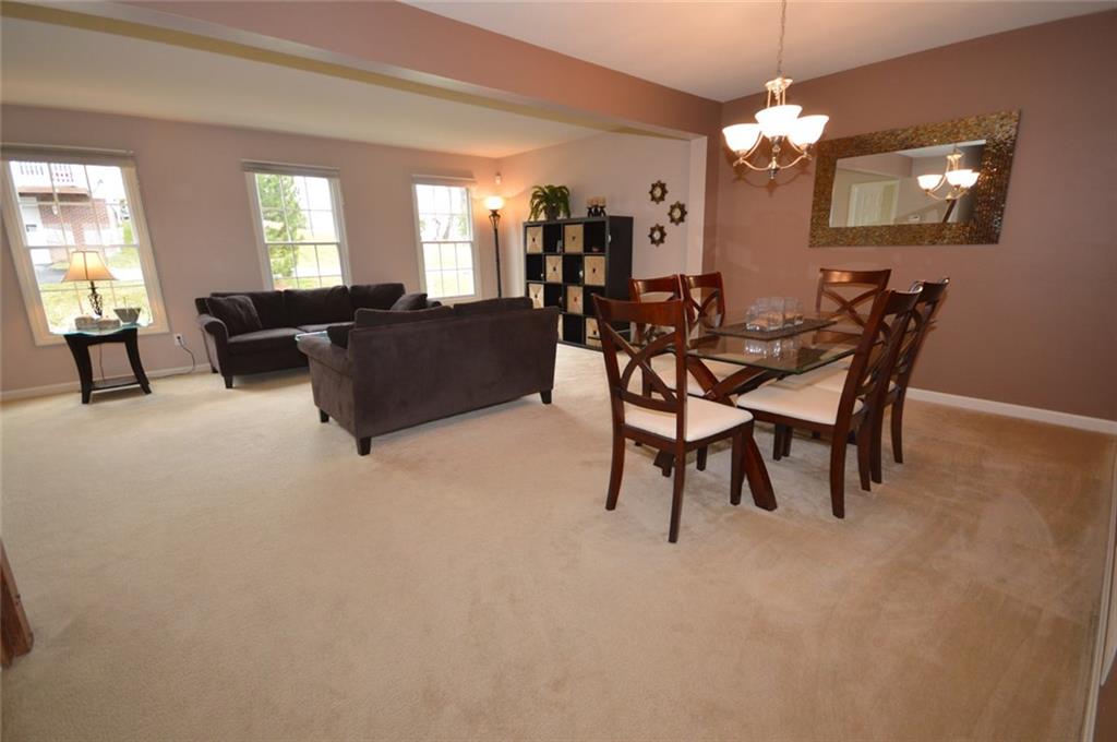 62 Castle View Drive McKees Rocks, PA 15136 - Photo 6 of 22 Another view of the spacious and roomy living room and dining room combination. The three living room windows allow sunshine and warmth to flow into this charming home. Come and see for yourself! You will be glad you did!