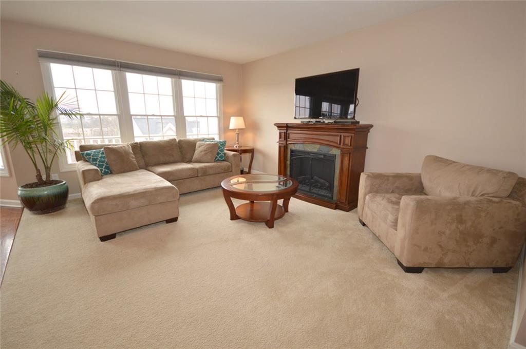 62 Castle View Drive McKees Rocks, PA 15136 - Photo 7 of 22 Family room - 16' x 13' - Come and enjoy this open floor plan in the spacious family room with an electric fireplace (that is staying with the home). There is a remote control that will change the temperature on the thermostat or turn off the heat. Enjoy the sunlight from the wall of windows that brightens this room. There is easy access to the full size 22' x 5' deck and eat-in-kitchen.