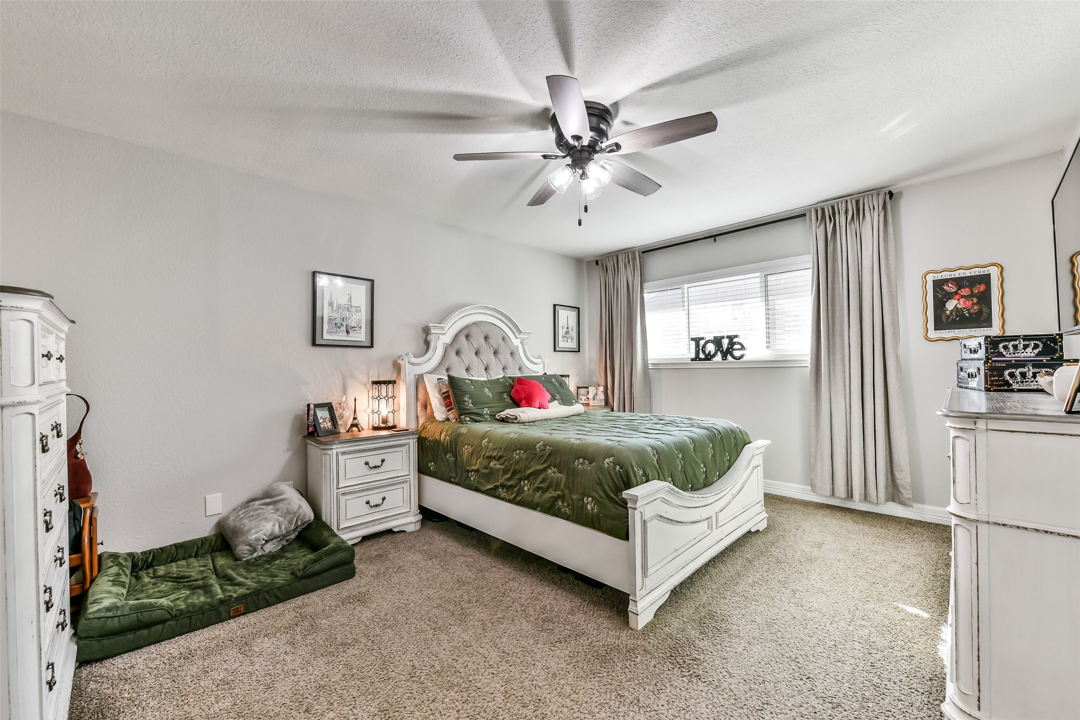 5421 Bramble Lane Dickinson, TX 77539 - Photo 15 of 26 a bedroom with a bed and a chandelier
