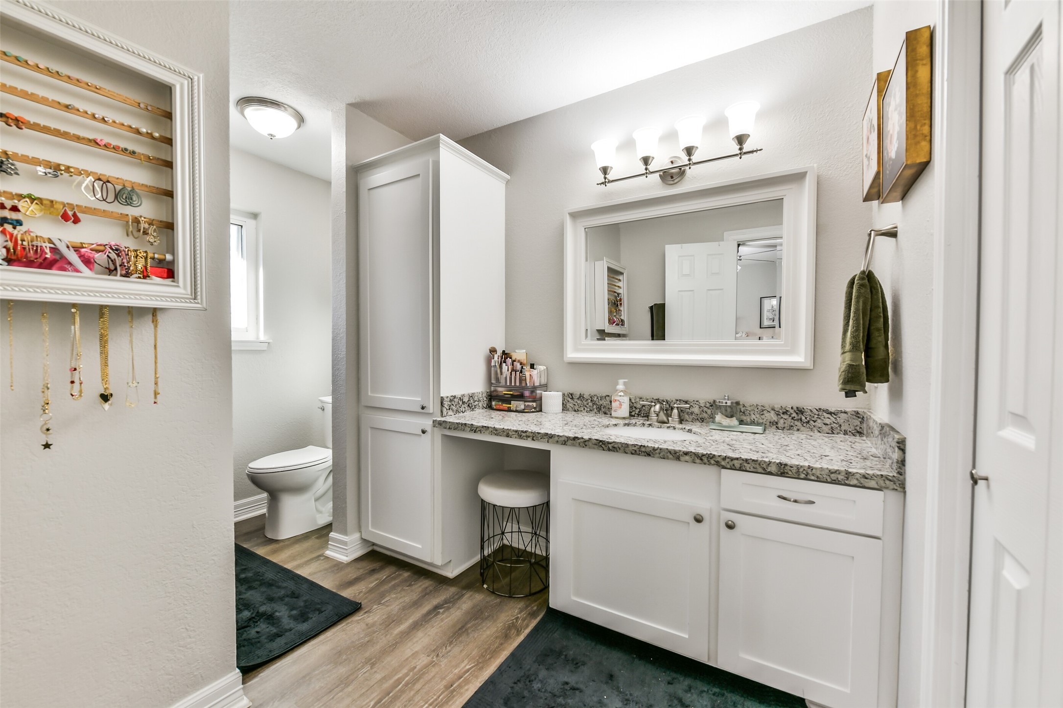 5421 Bramble Lane Dickinson, TX 77539 - Photo 17 of 26 a bathroom with a granite countertop sink a toilet and a mirror