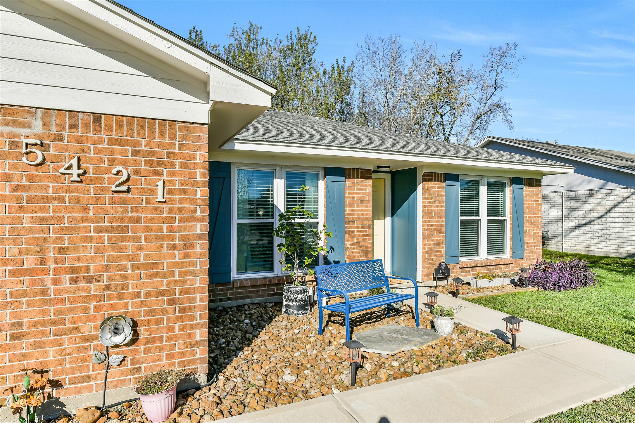 5421 Bramble Lane Dickinson, TX 77539 - Photo 2 of 26 a bench sitting in front of a house